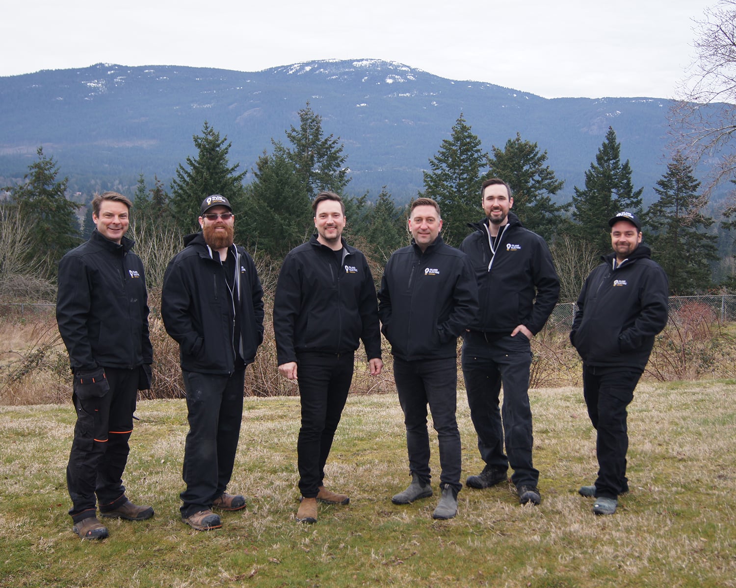 The Island Electric crew, with Mount Benson in the background on a typically-grey Nanaimo day