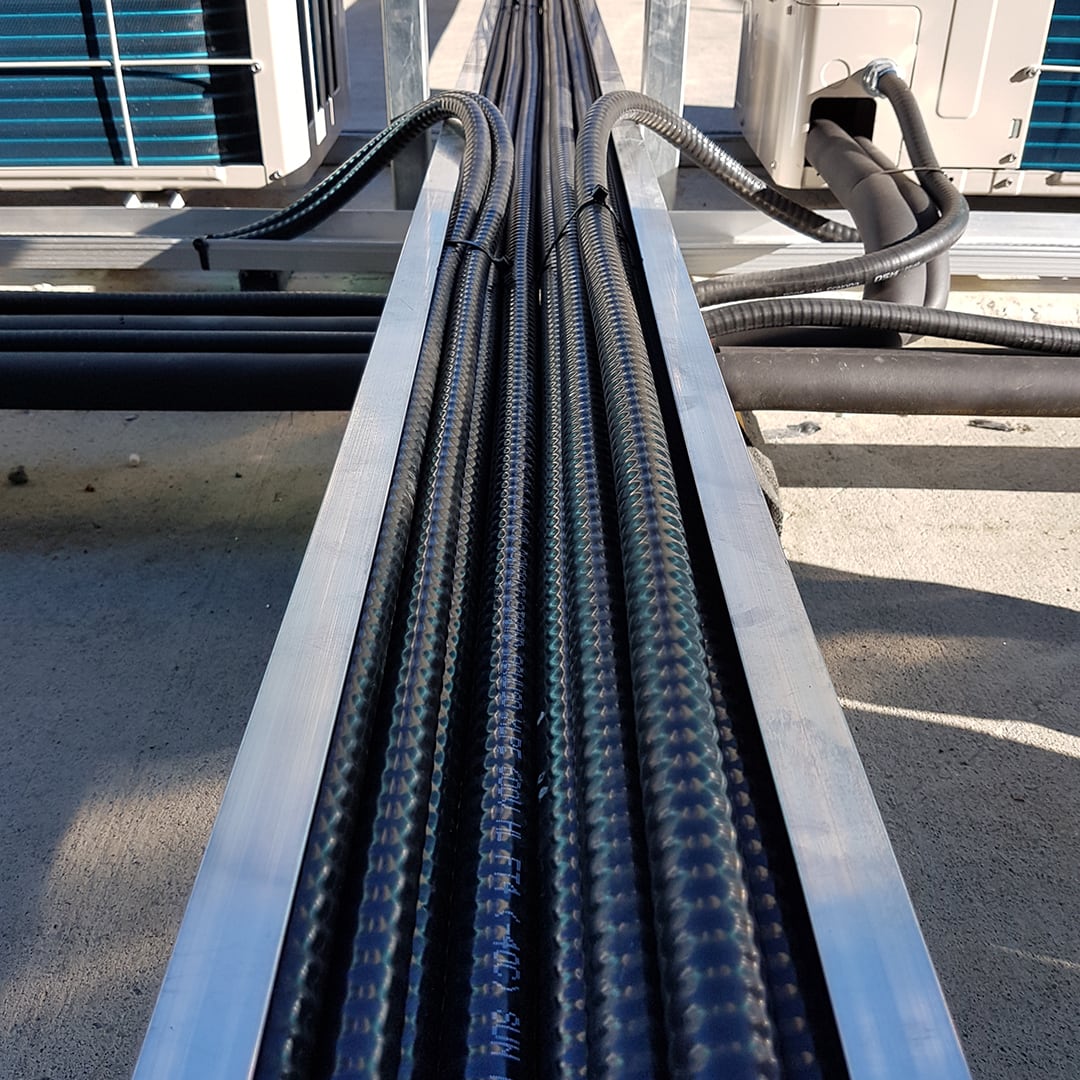 Low-angle view of black cables organized neatly and stretching forward into the distance